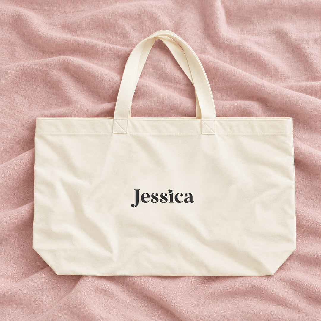 Natural cream canvas personalised bridesmaid XL tote bag with the name Jessica, on blush linen