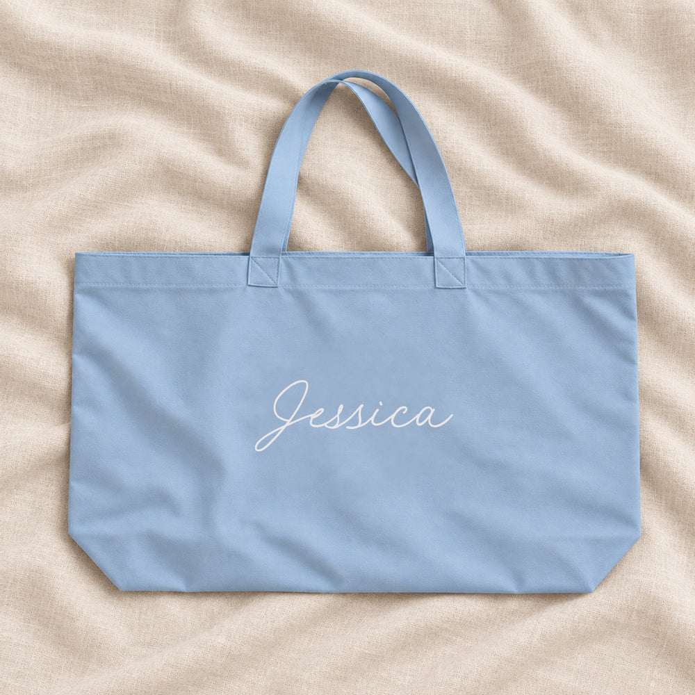 Dusty blue personalised bridesmaid XL tote bag with the name Jessica in script, on cream linen