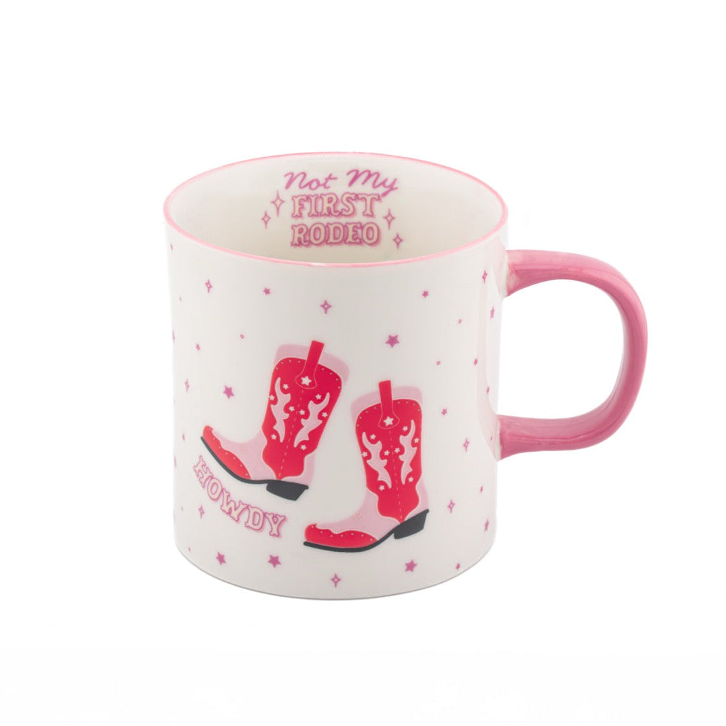 White mug with pink handle and red cowboy boots design on a white background