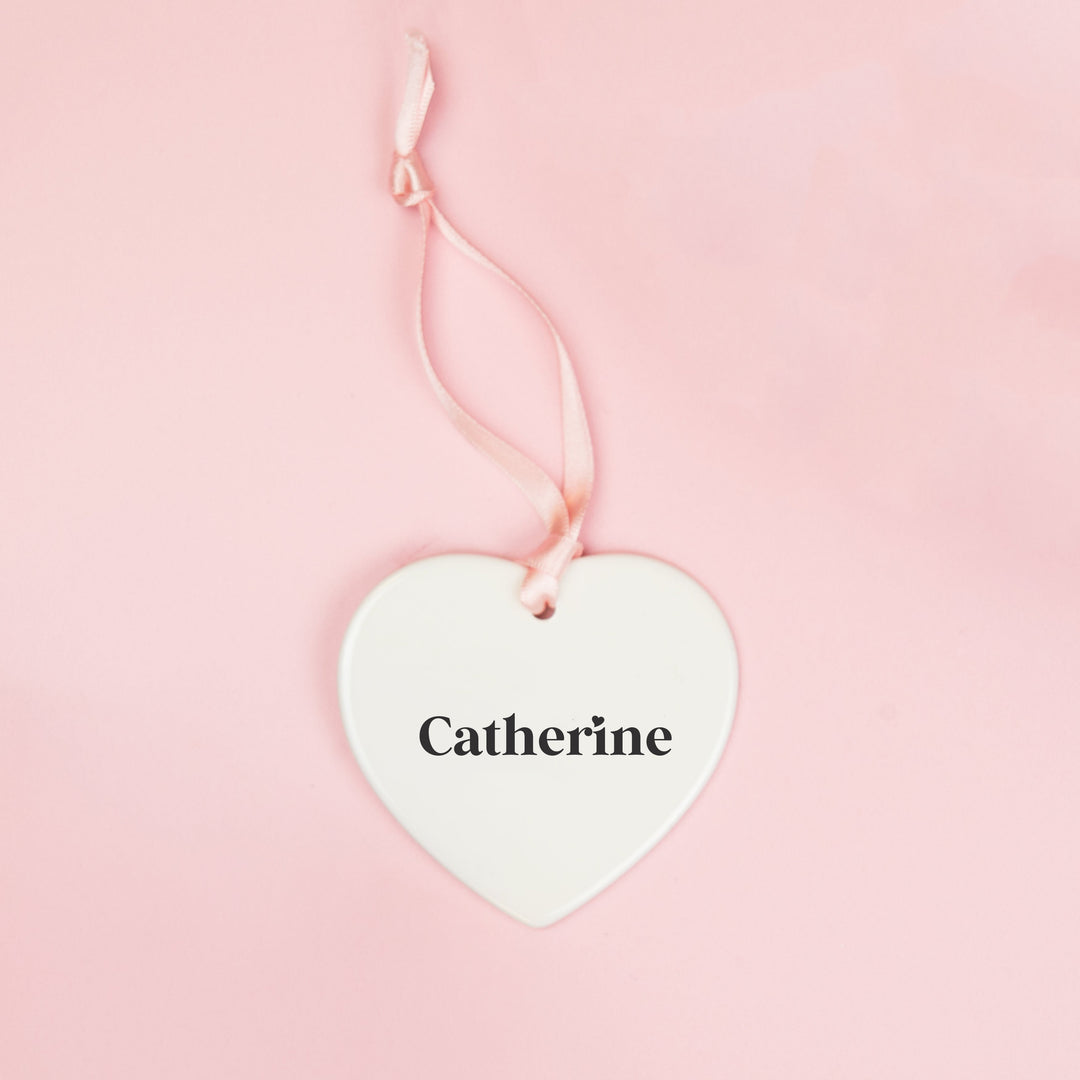 White ceramic heart keepsake personalised with a bridesmaid’s name in black lettering