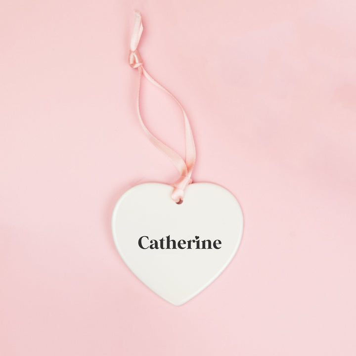 White ceramic heart keepsake personalised with a bridesmaid’s name in black lettering